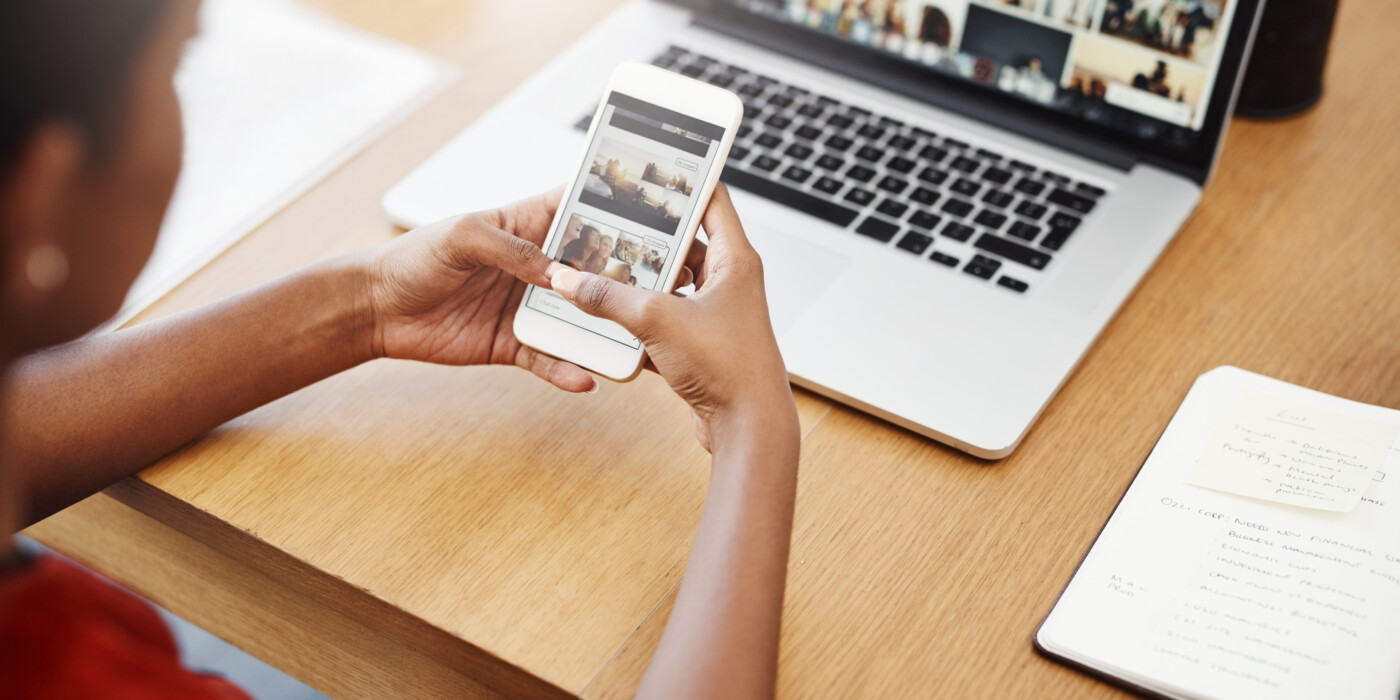 Cropped shot of an unrecognizable businesswoman using a cellphone in her home office.